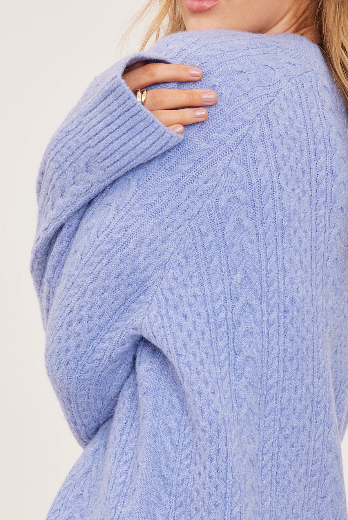 Lori sweater in a cozy heathered knit with a classic crew neckline, oversized fit, and allover cable knit detailing for a textured finish.