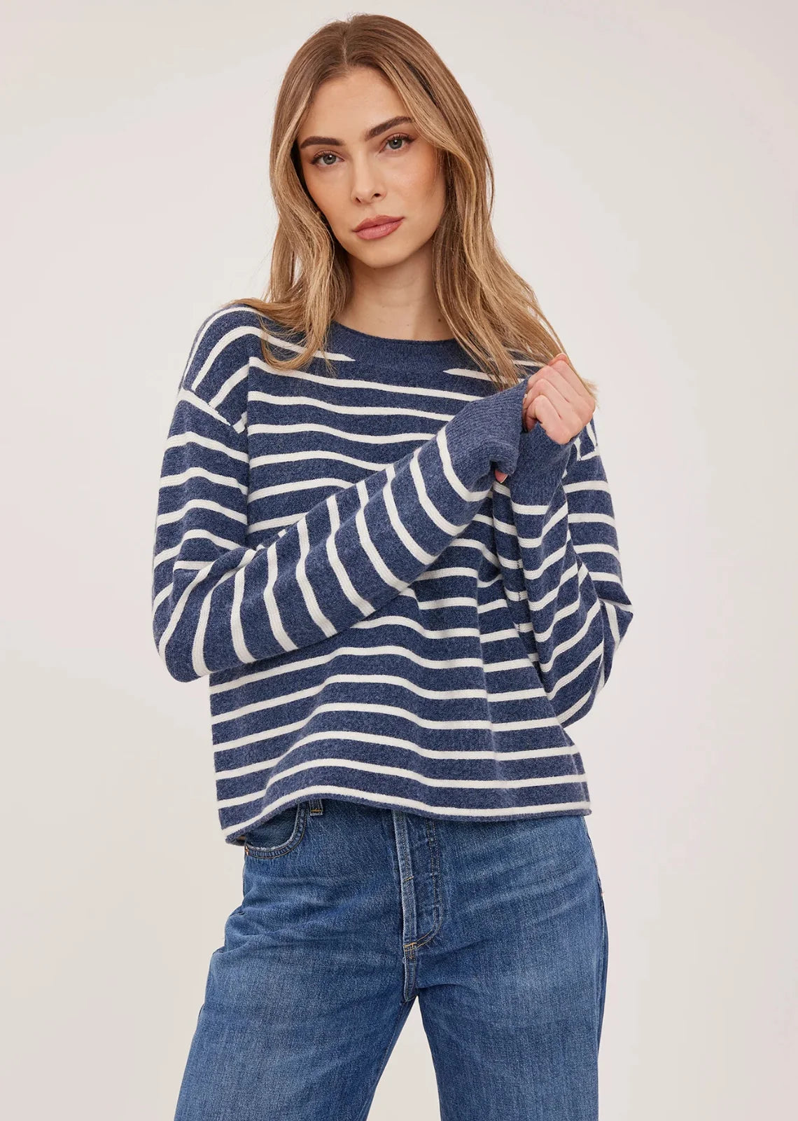 Wanda relaxed-fit sweater in navy with white stripes made from soft, brushed yarn, featuring rolled edges at the neckline and hem for an effortless, casual look.