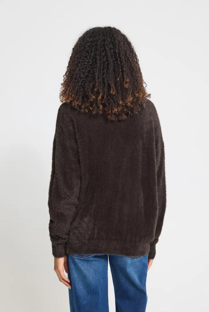 Knit cardigan in a light Cloud Dancer shade featuring a relaxed fit, long sleeves, and a button-front closure with a cozy textured finish.
