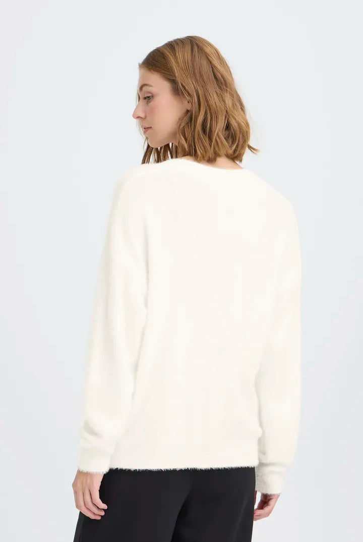 Knit cardigan in a light Cloud Dancer shade featuring a relaxed fit, long sleeves, and a button-front closure with a cozy textured finish.