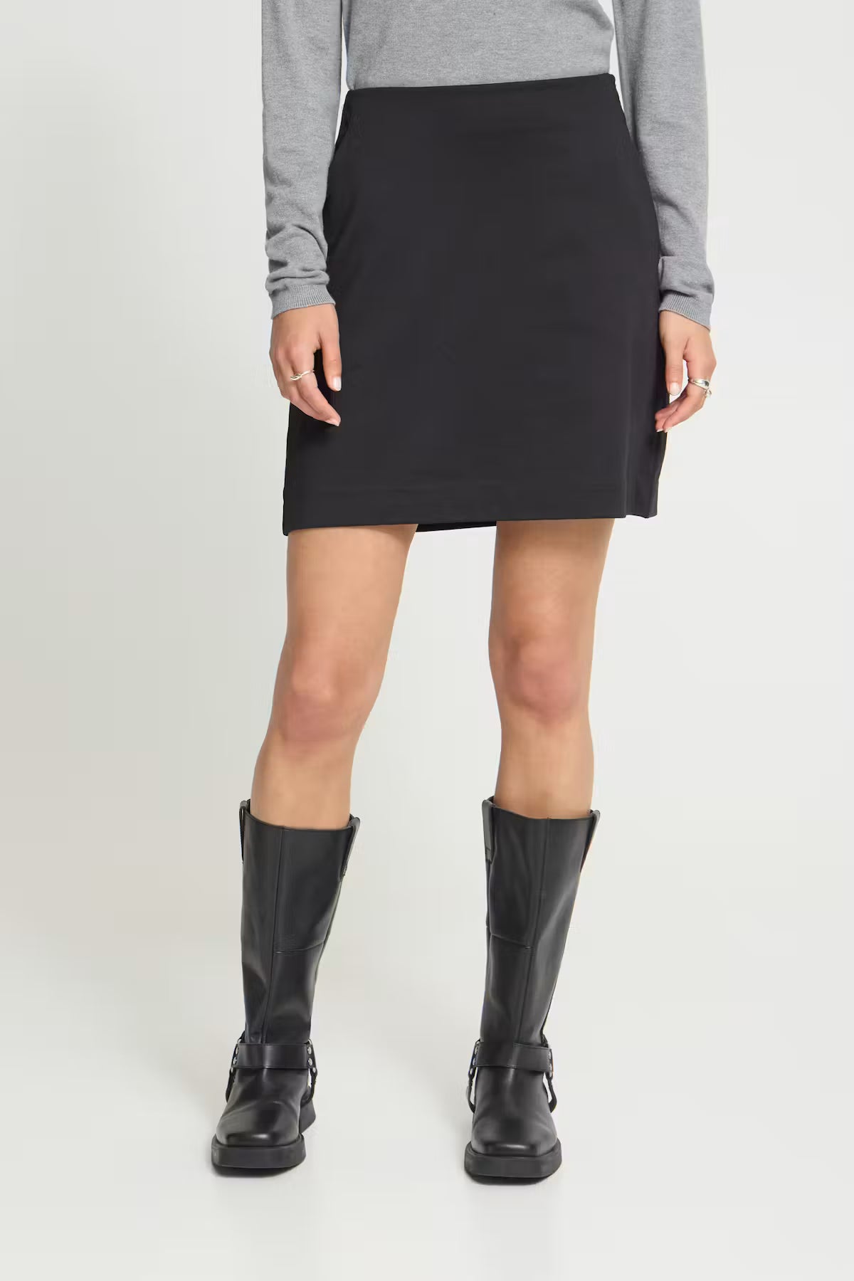 Mini skirt featuring a fitted waist, clean straight silhouette, and smooth soft-touch finish.