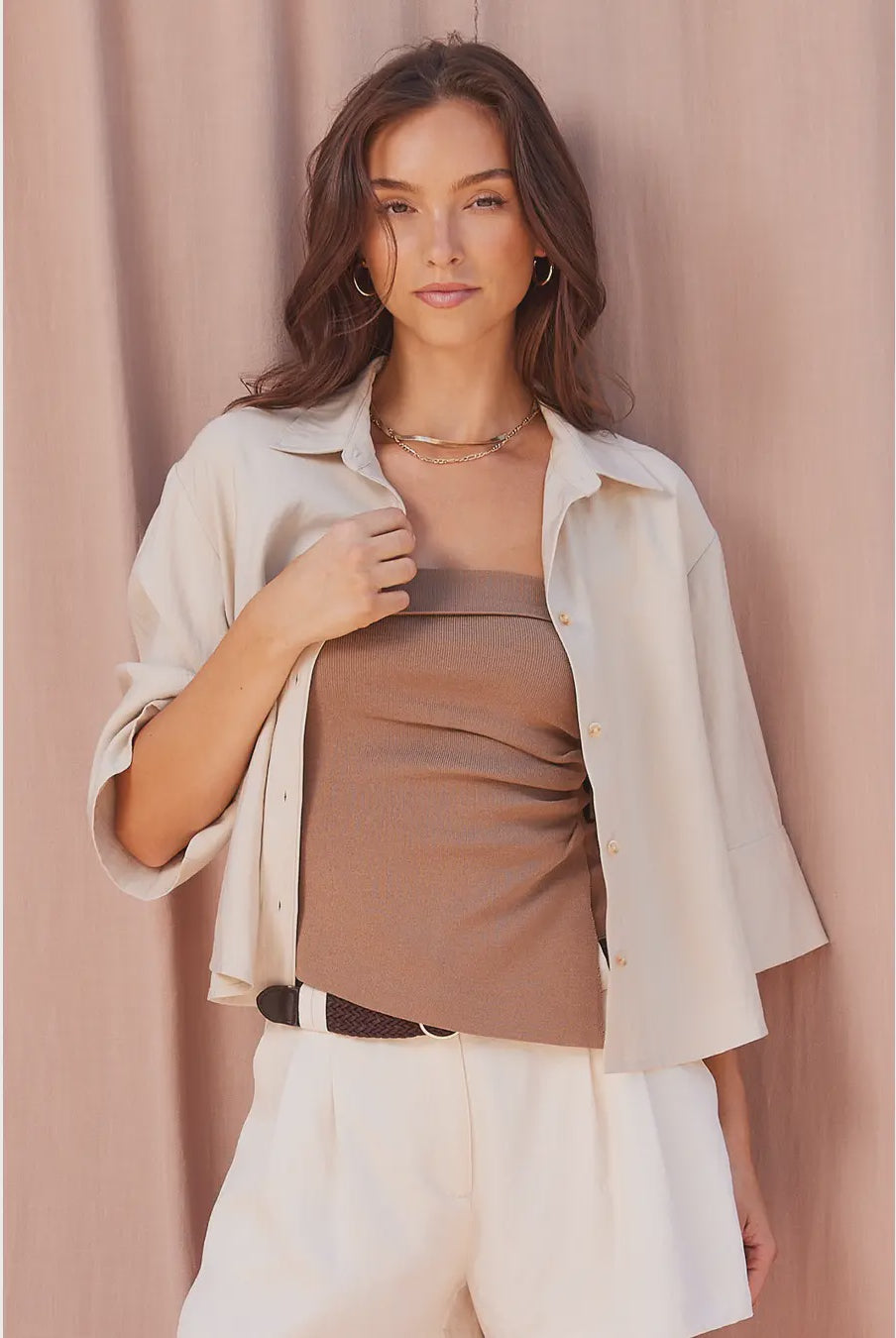 Lena strapless knit top in a fitted silhouette, featuring a ruched side detail and asymmetrical hem for a sleek, modern look.