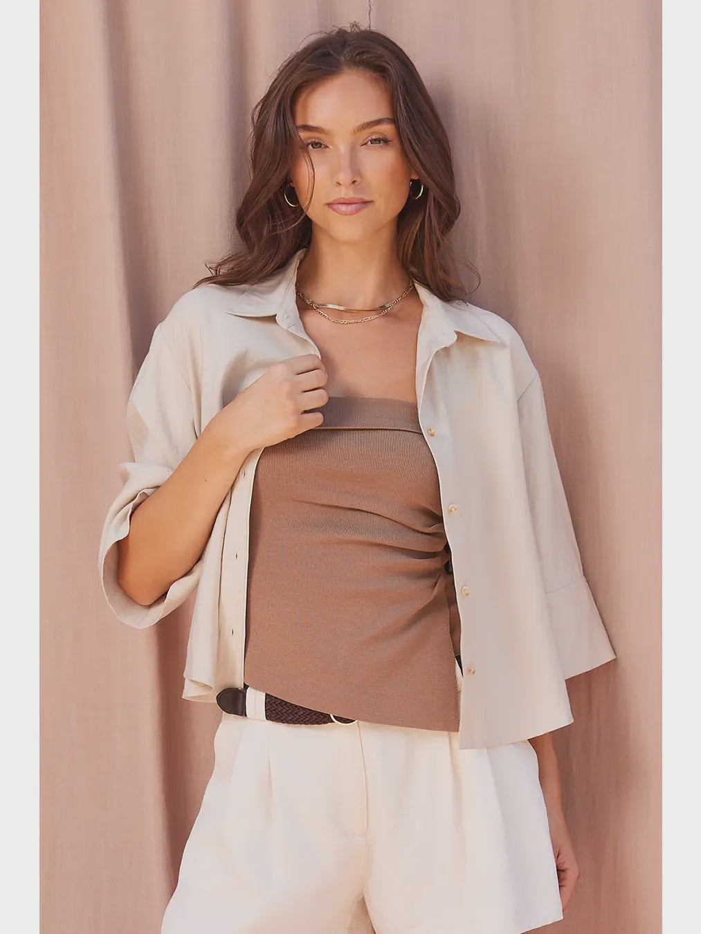 Lena strapless knit top in a fitted silhouette, featuring a ruched side detail and asymmetrical hem for a sleek, modern look.