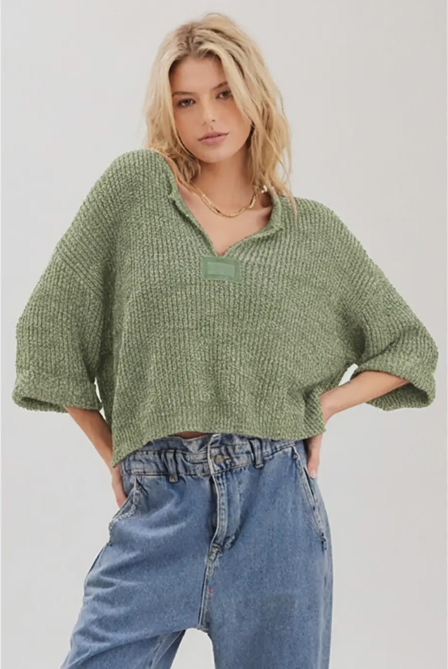Lora chunky cropped sweater with a loose slouchy fit, V-neckline, relaxed ¾ sleeves, and contrasting solid patch details on the front and back.