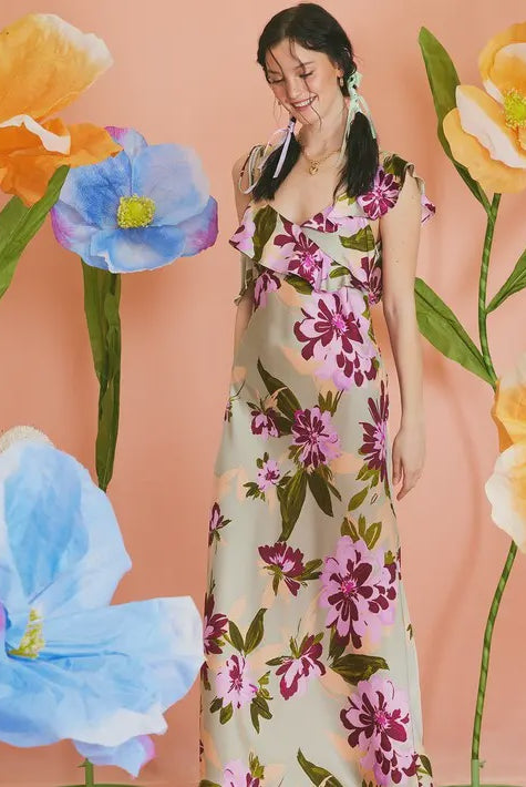 woman wearing floral sage satin maxi dress with ruffle detailing