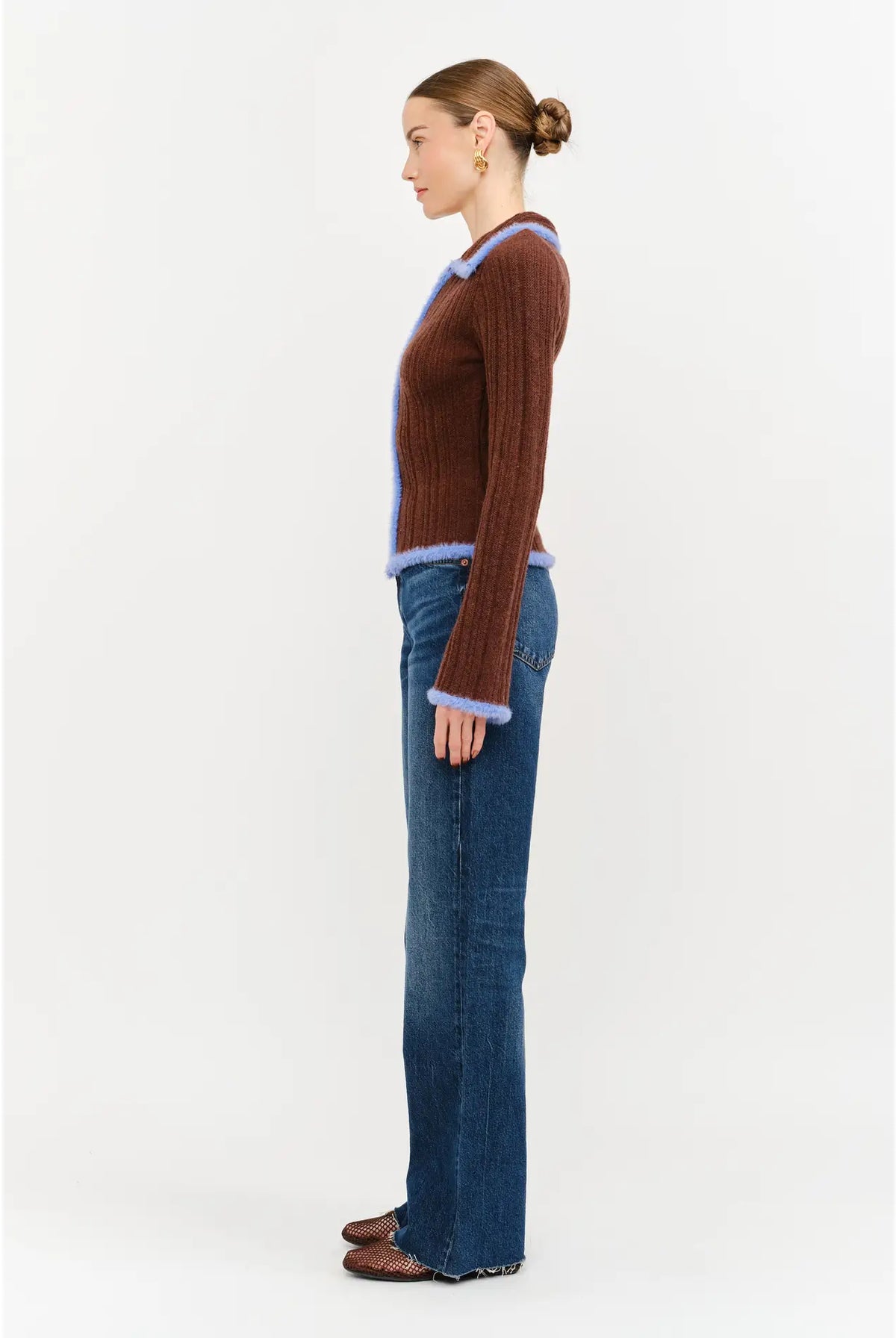 Model wearing the Jacquie Knit Top in brown, featuring a fitted silhouette, long sleeves, collared neckline, contrasting blue fuzzy trim, and two-way front zipper closure.