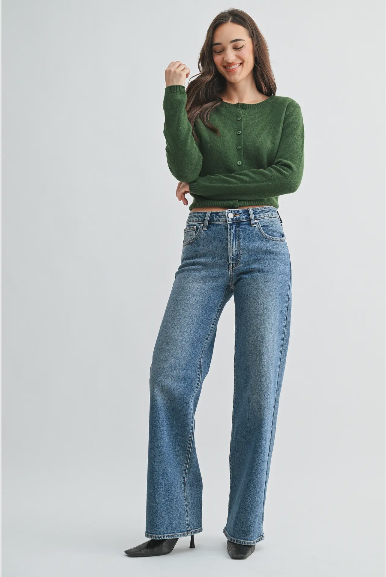 woman wearing a medium wash wide leg jean with a 33 inch inseam