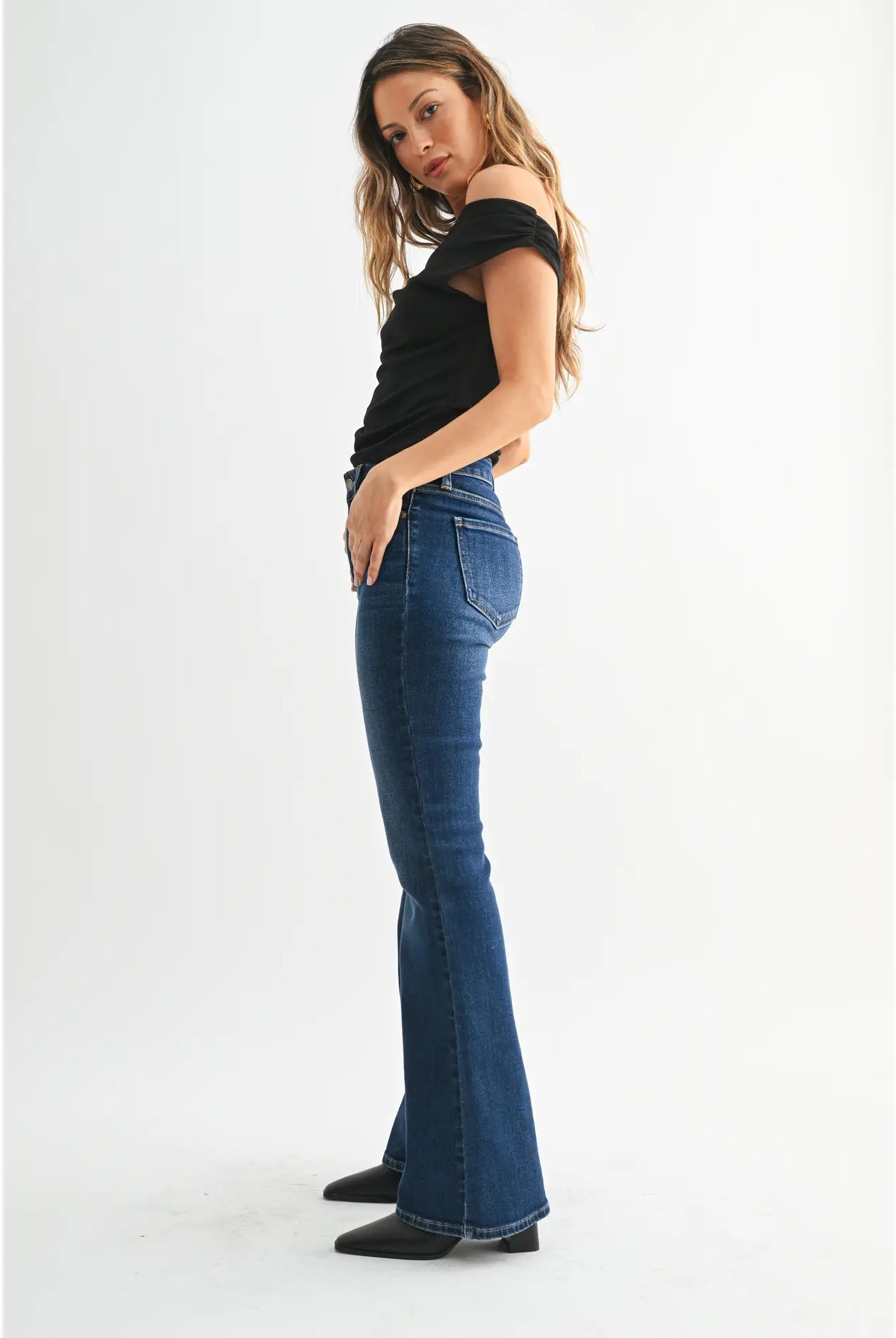 Dark denim mid-rise flare jeans with a fitted waist, hips, and thighs and a full-length leg that opens into a sleek, flattering flare.