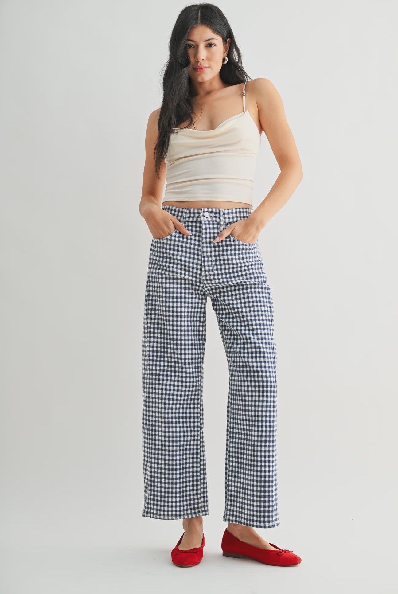 woman wearing an ankle length barrel jean in a navy and white ginham print