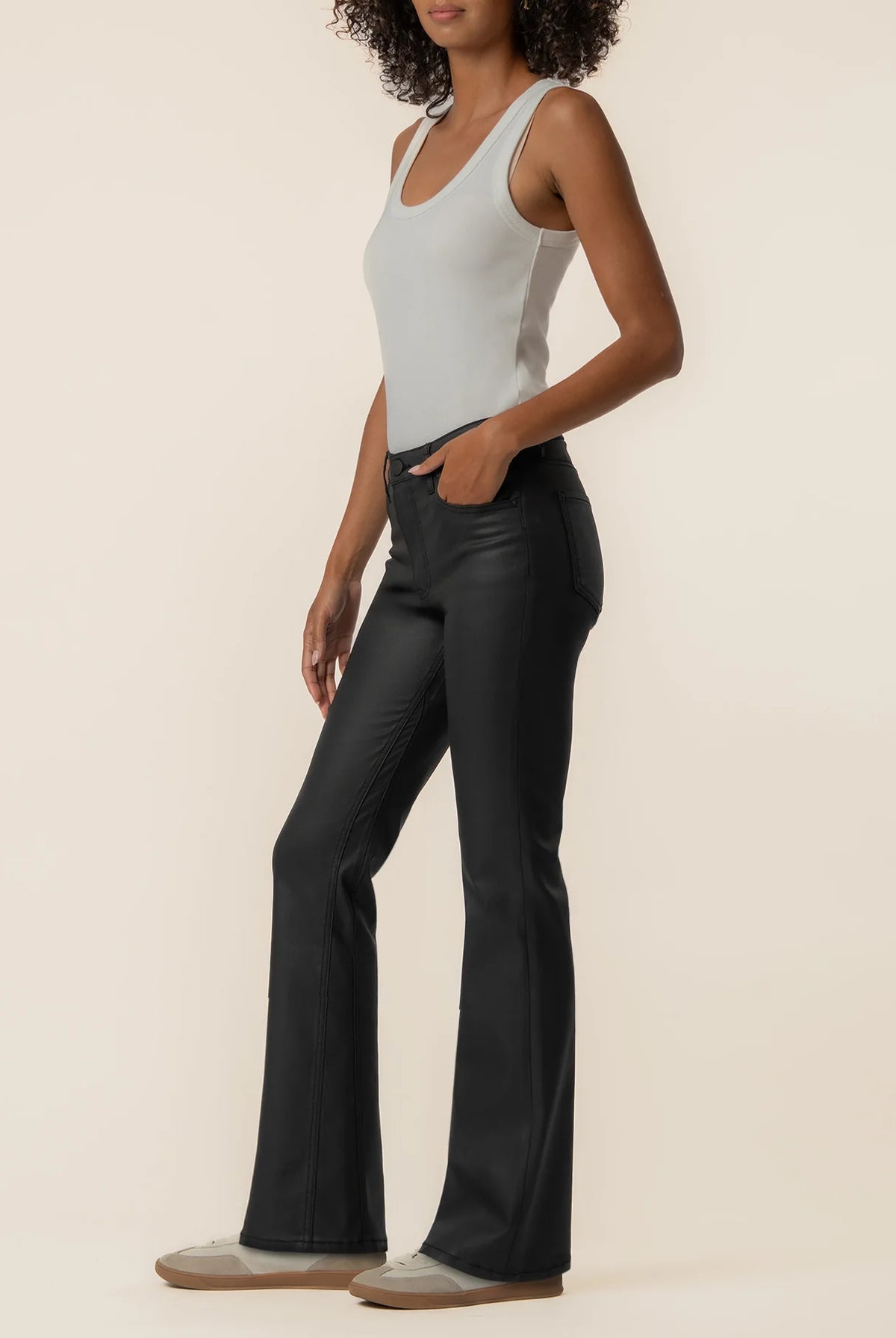 High-rise kick flare pants in Matte Black featuring a sleek coated finish, Fab Ab front pockets, inset leg detailing, and a flattering flared silhouette.