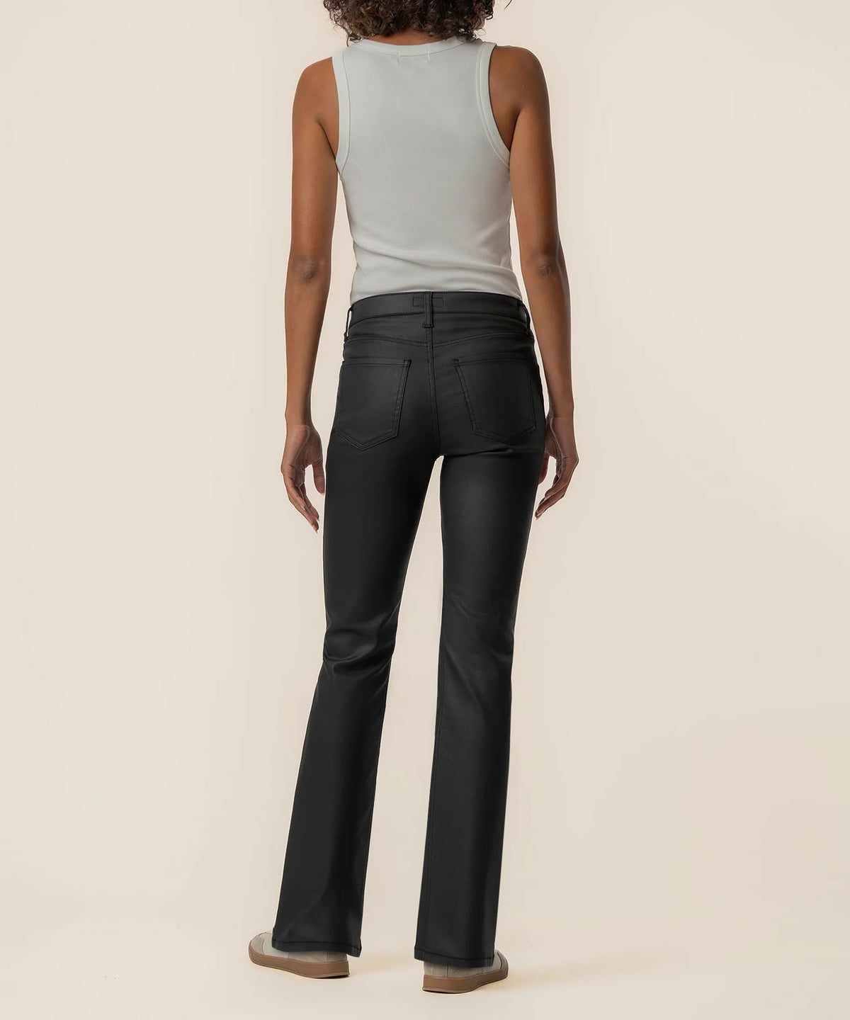 High-rise kick flare pants in Matte Black featuring a sleek coated finish, Fab Ab front pockets, inset leg detailing, and a flattering flared silhouette.