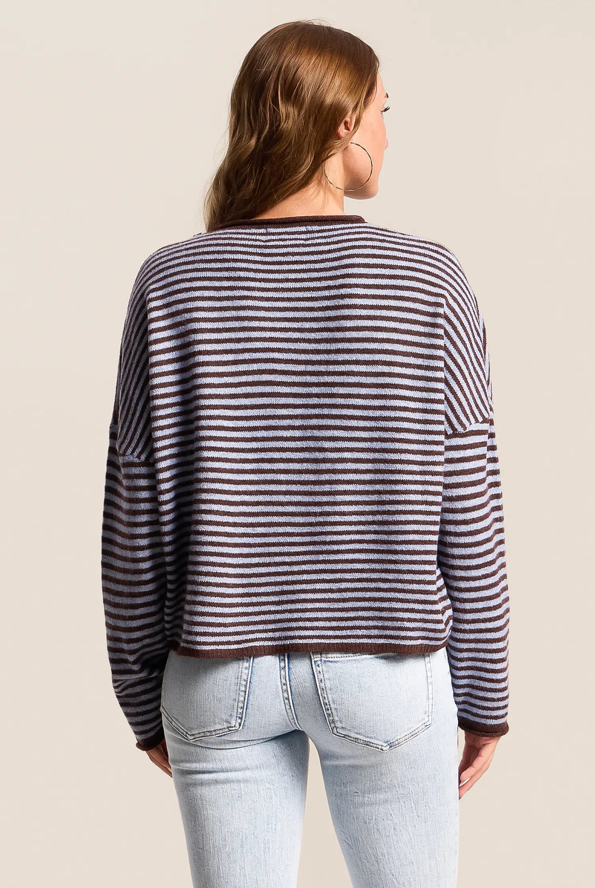 blue cardigan with dark brown horizontal stripes. button down closure. long sleeves