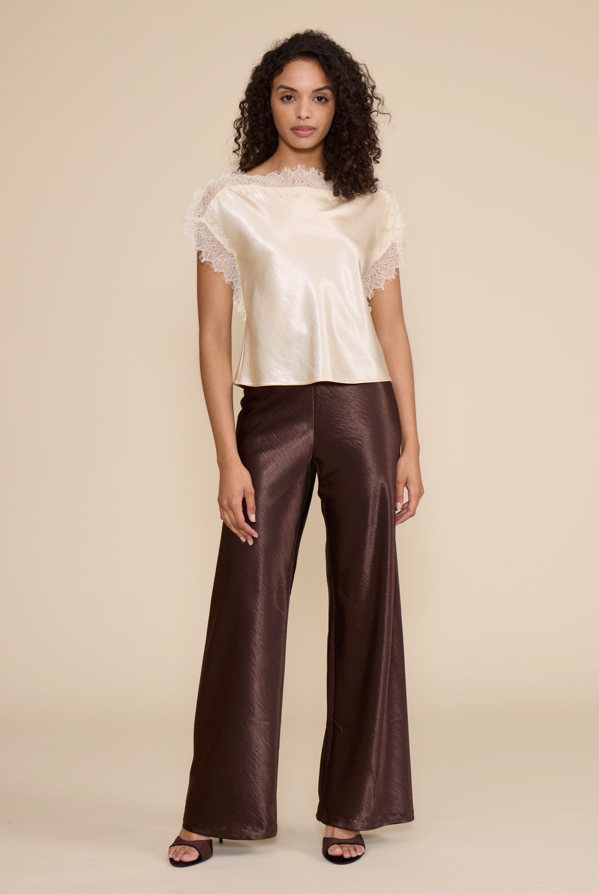 Lucy Paris Chris Lace Trim Top in ivory featuring a silky finish, relaxed fit, and delicate sheer lace trim along the neckline and short sleeves.