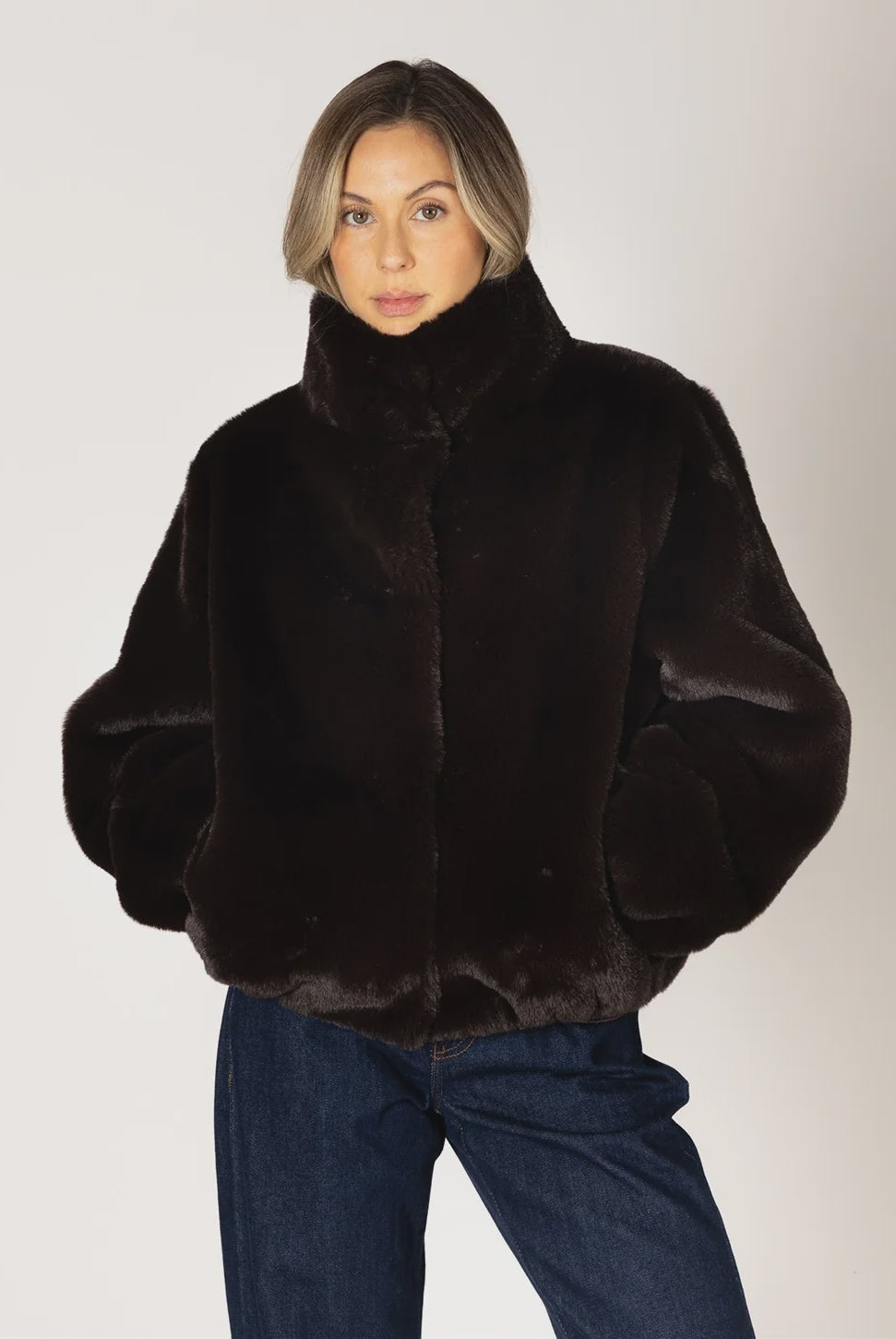 Kendra Short Faux Fur Coat in espresso brown featuring a soft, plush faux fur texture, relaxed fit, cropped silhouette, crew neckline, long sleeves, and front button closure.