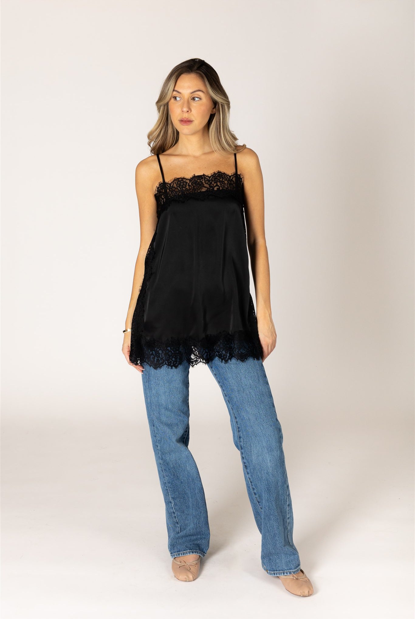Black lace trim camisole top with delicate lace detailing at the neckline and hem.
