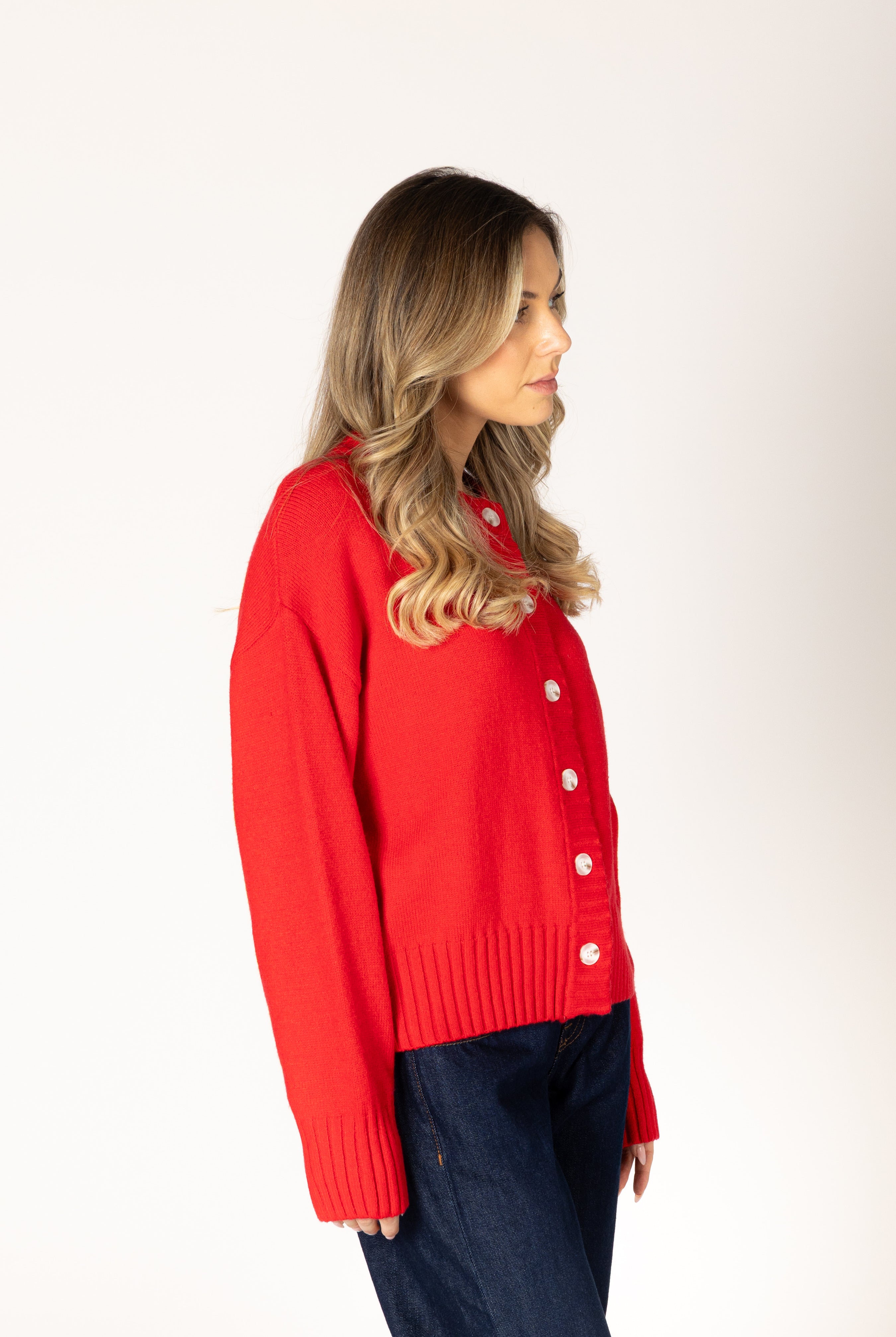 Neutral knit cardigan featuring a classic crew neckline, button-front closure, and ribbed detailing for a timeless, polished look.