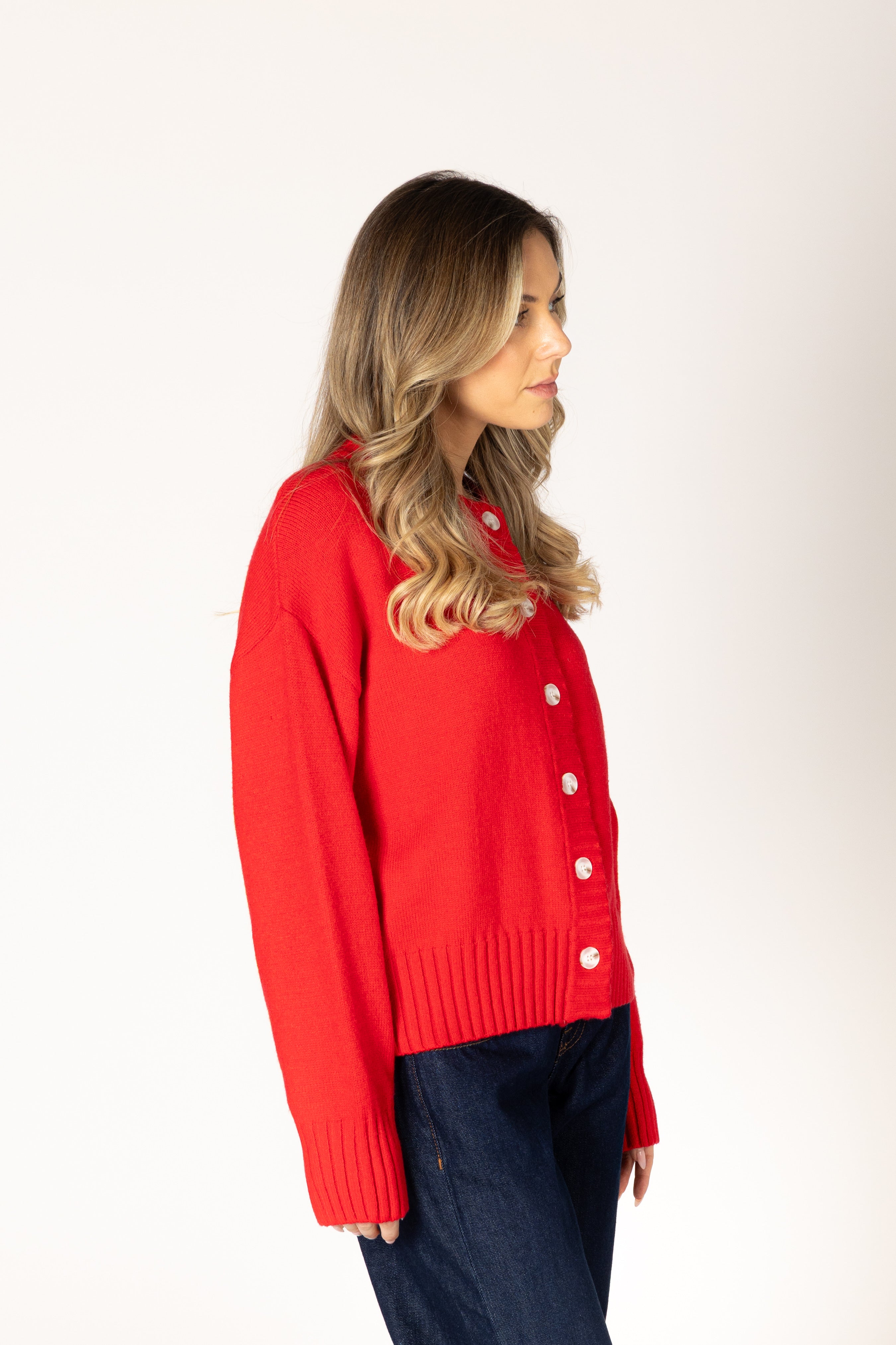 Neutral knit cardigan featuring a classic crew neckline, button-front closure, and ribbed detailing for a timeless, polished look.