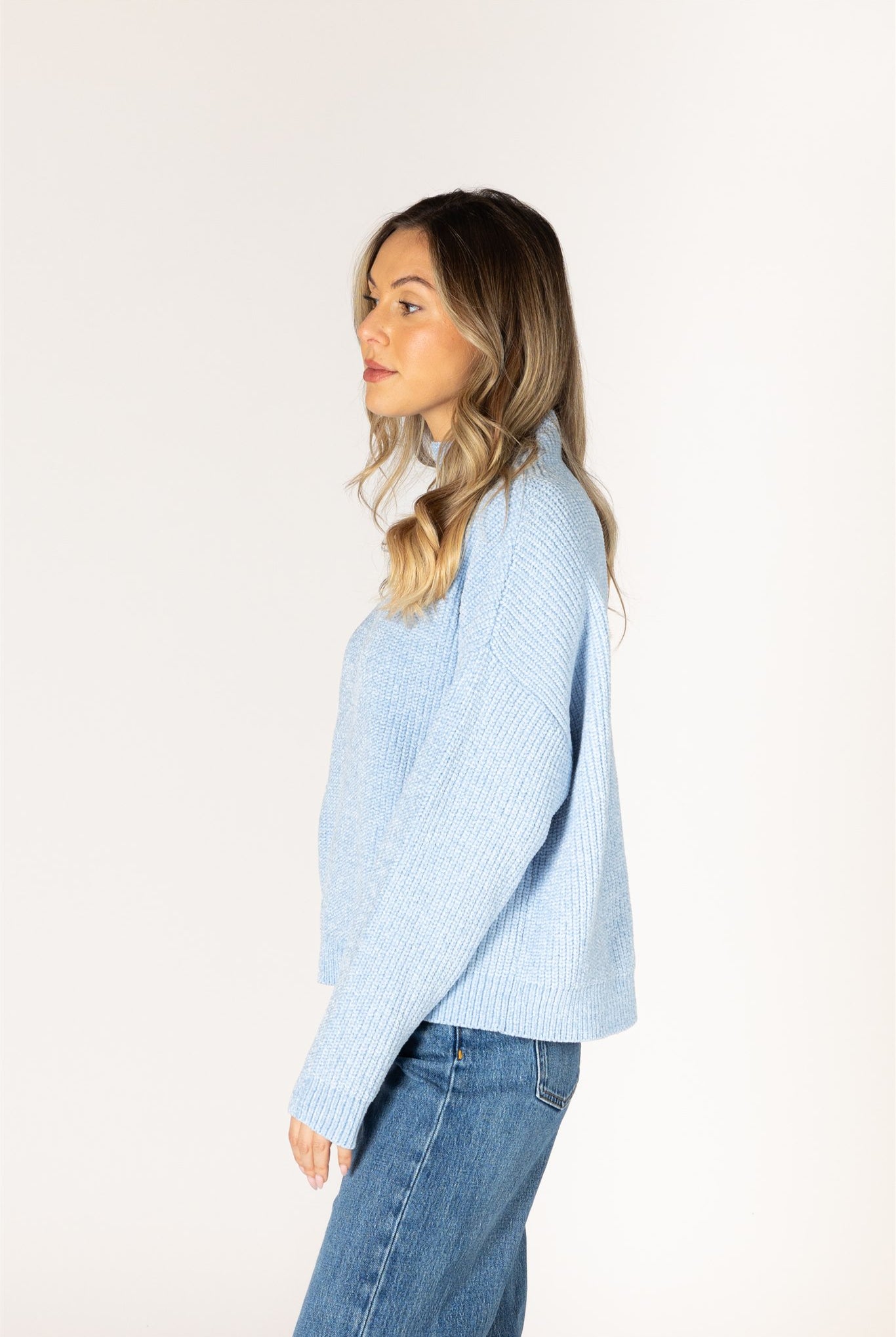 Sky blue ribbed knit sweater featuring a mock neckline, relaxed fit, and long sleeves.