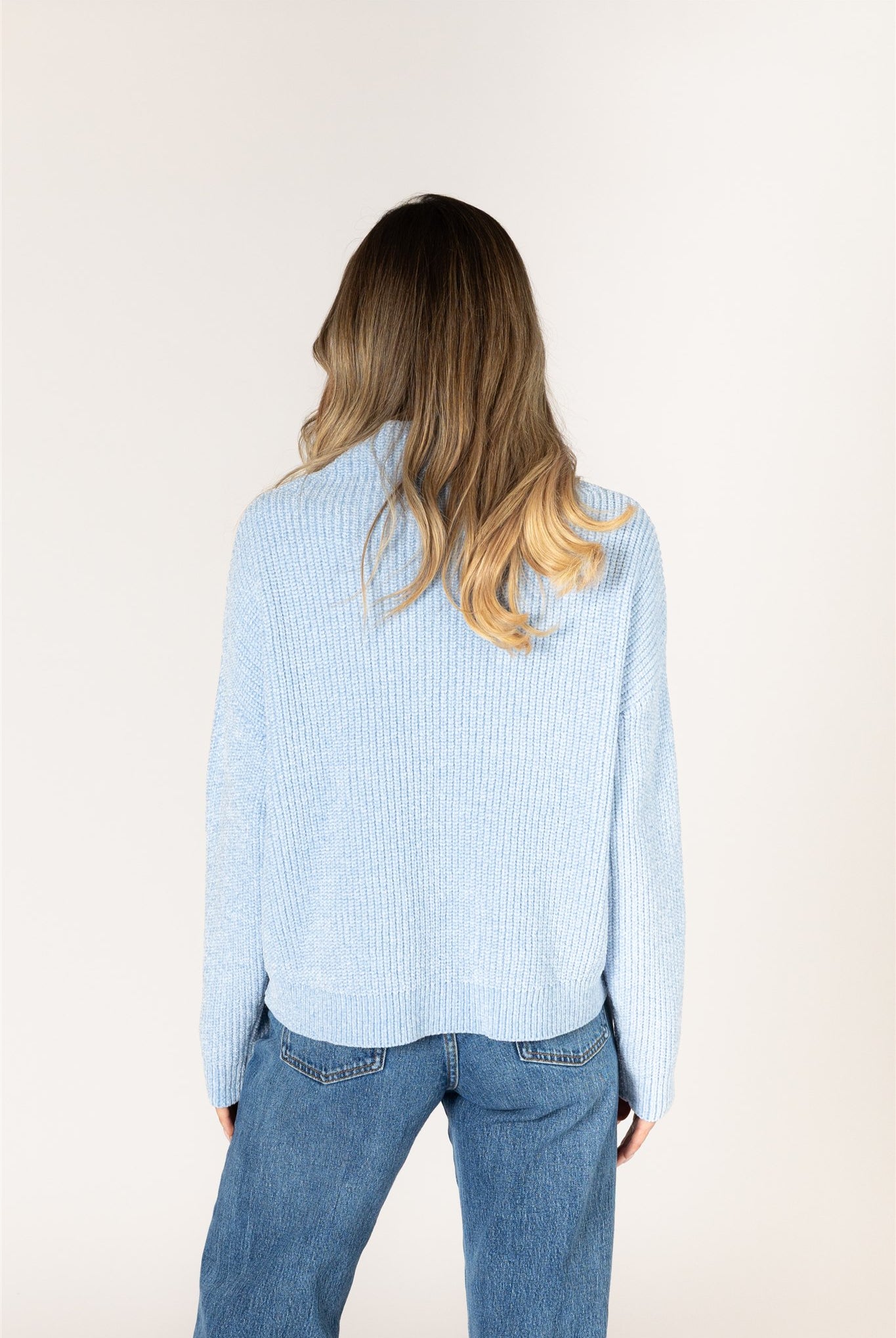 Sky blue ribbed knit sweater featuring a mock neckline, relaxed fit, and long sleeves.