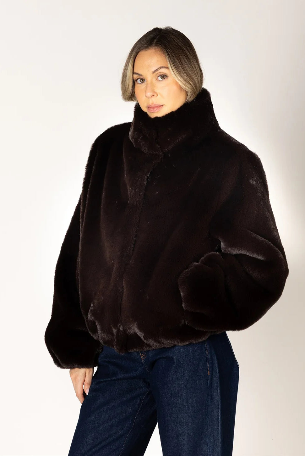 Kendra Short Faux Fur Coat in espresso brown featuring a soft, plush faux fur texture, relaxed fit, cropped silhouette, crew neckline, long sleeves, and front button closure.