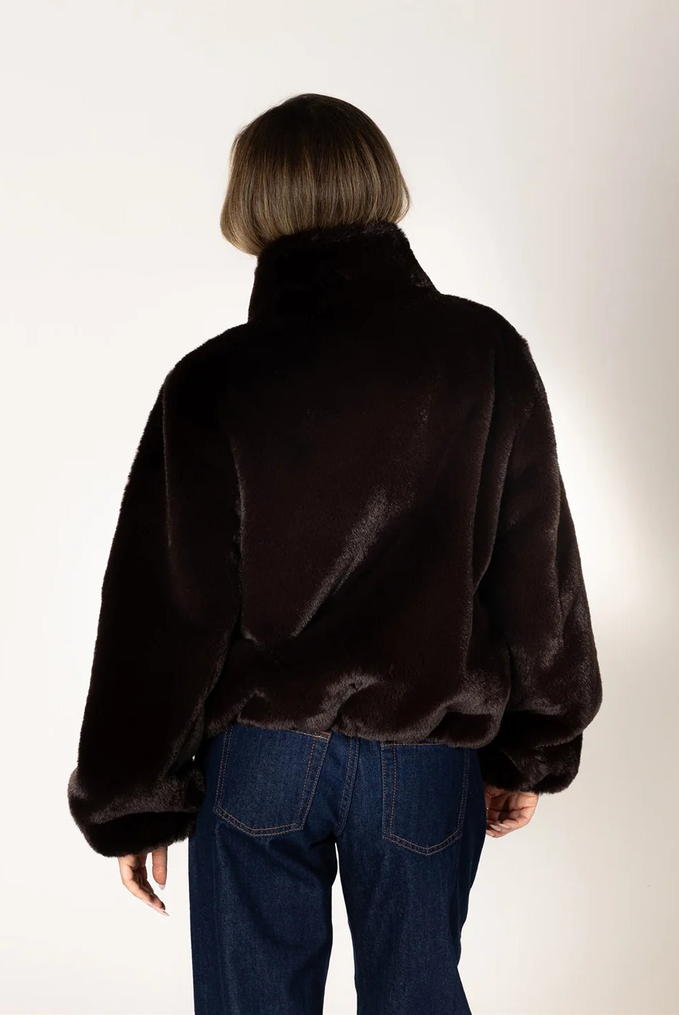 Kendra Short Faux Fur Coat in espresso brown featuring a soft, plush faux fur texture, relaxed fit, cropped silhouette, crew neckline, long sleeves, and front button closure.