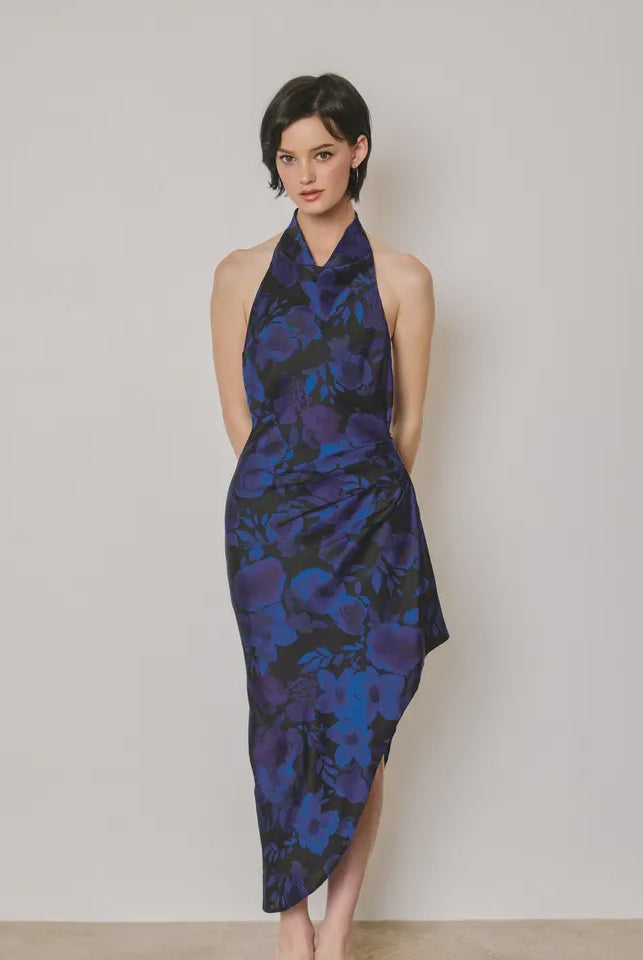 Midnight Bloom floral halter dress featuring a softly draped neckline, ruching at the waist, open-back design, asymmetrical hemline, side zipper closure, and partial lining.