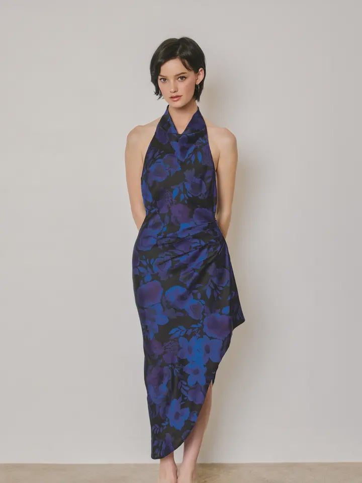 Midnight Bloom floral halter dress featuring a softly draped neckline, ruching at the waist, open-back design, asymmetrical hemline, side zipper closure, and partial lining.
