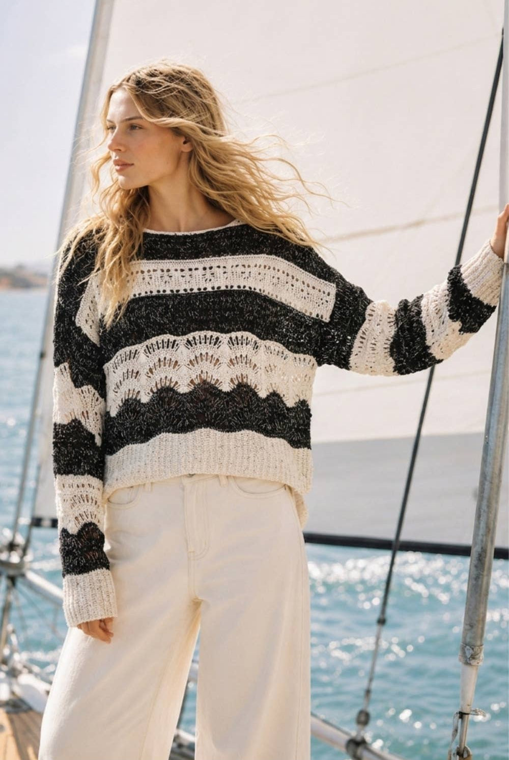 The Elowyn Open-Stitch Sweater in cream and black, featuring a sheer crochet-inspired texture and semi-cropped silhouette.