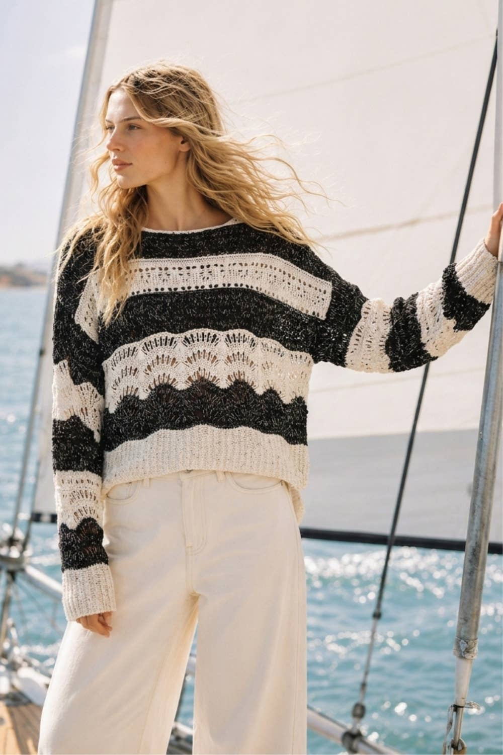 The Elowyn Open-Stitch Sweater in cream and black, featuring a sheer crochet-inspired texture and semi-cropped silhouette.