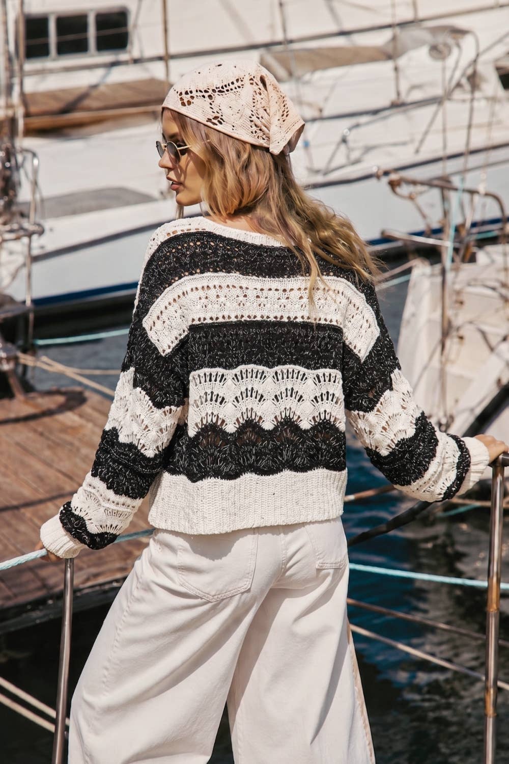 The Elowyn Open-Stitch Sweater in cream and black, featuring a sheer crochet-inspired texture and semi-cropped silhouette.