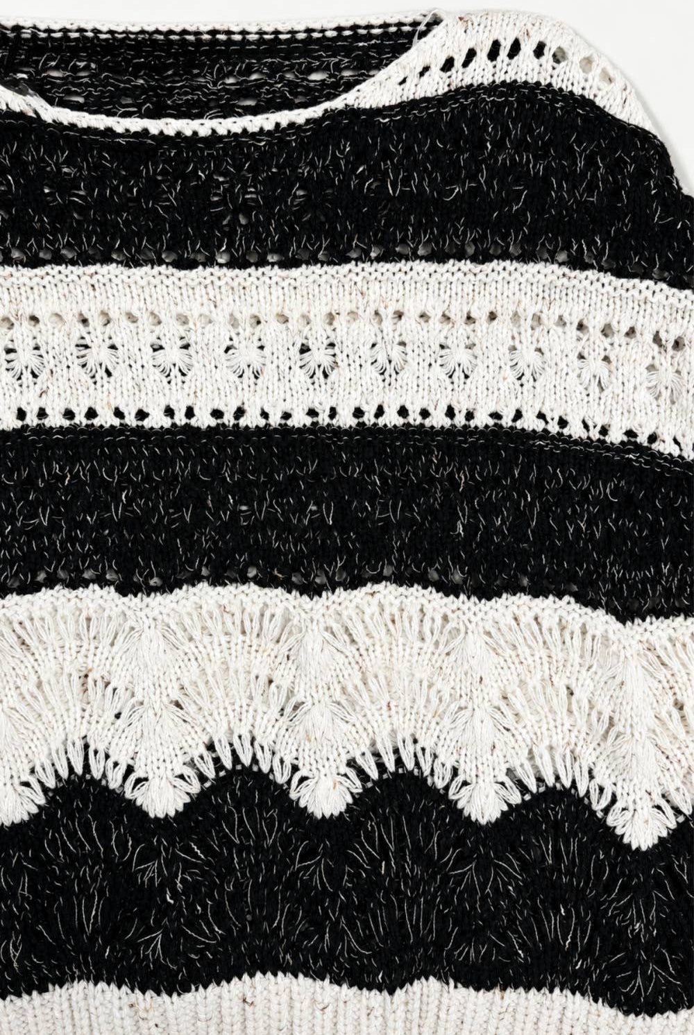 The Elowyn Open-Stitch Sweater in cream and black, featuring a sheer crochet-inspired texture and semi-cropped silhouette.