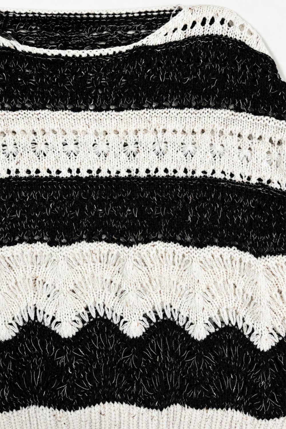 The Elowyn Open-Stitch Sweater in cream and black, featuring a sheer crochet-inspired texture and semi-cropped silhouette.