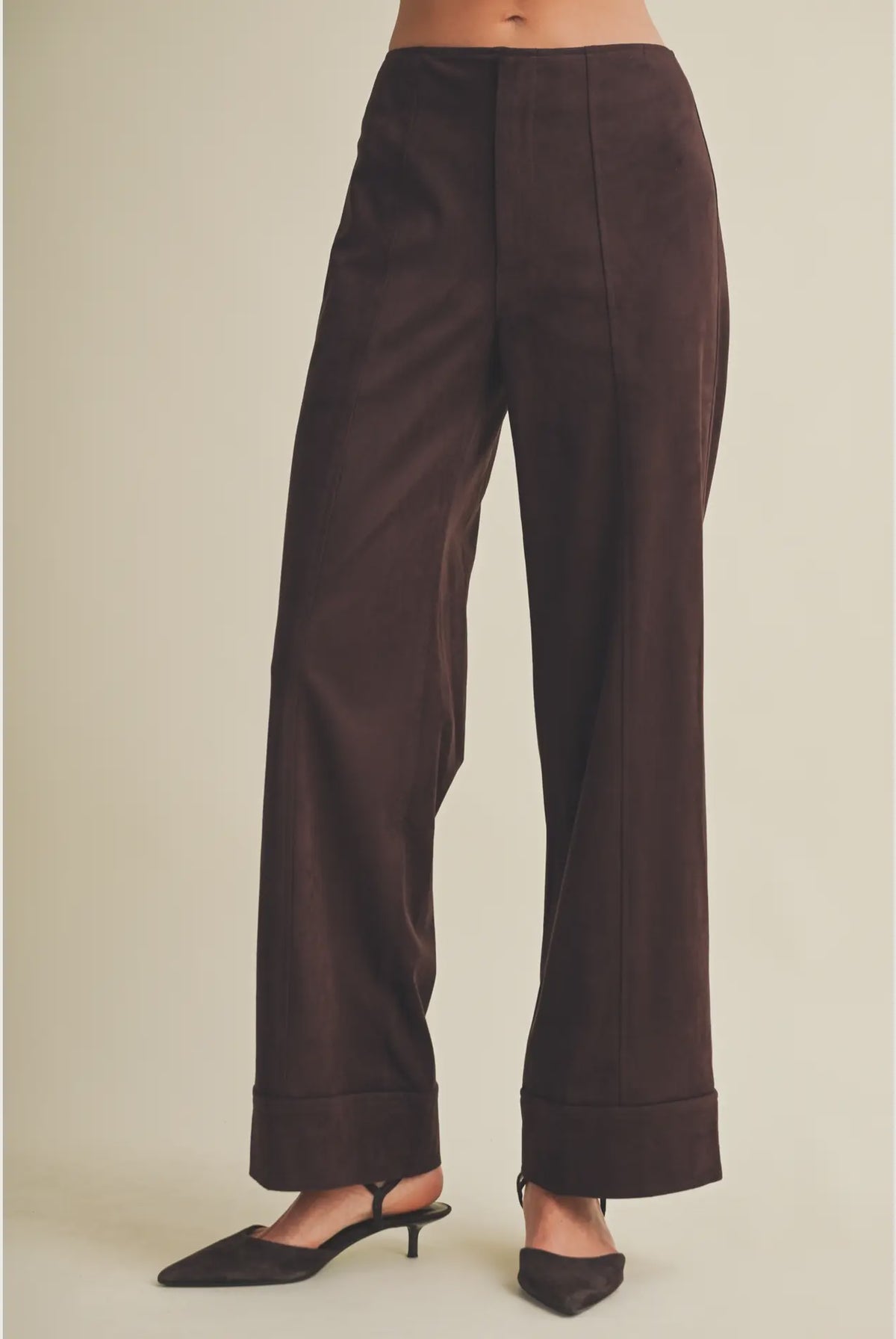 High-waisted faux suede pants with a slim wide-leg silhouette, pintuck detailing, full length, and wide cuffed hems. Model is 5'9" and wearing a size Small.