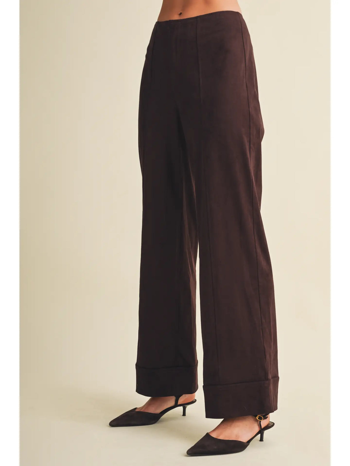 High-waisted faux suede pants with a slim wide-leg silhouette, pintuck detailing, full length, and wide cuffed hems. Model is 5'9" and wearing a size Small.