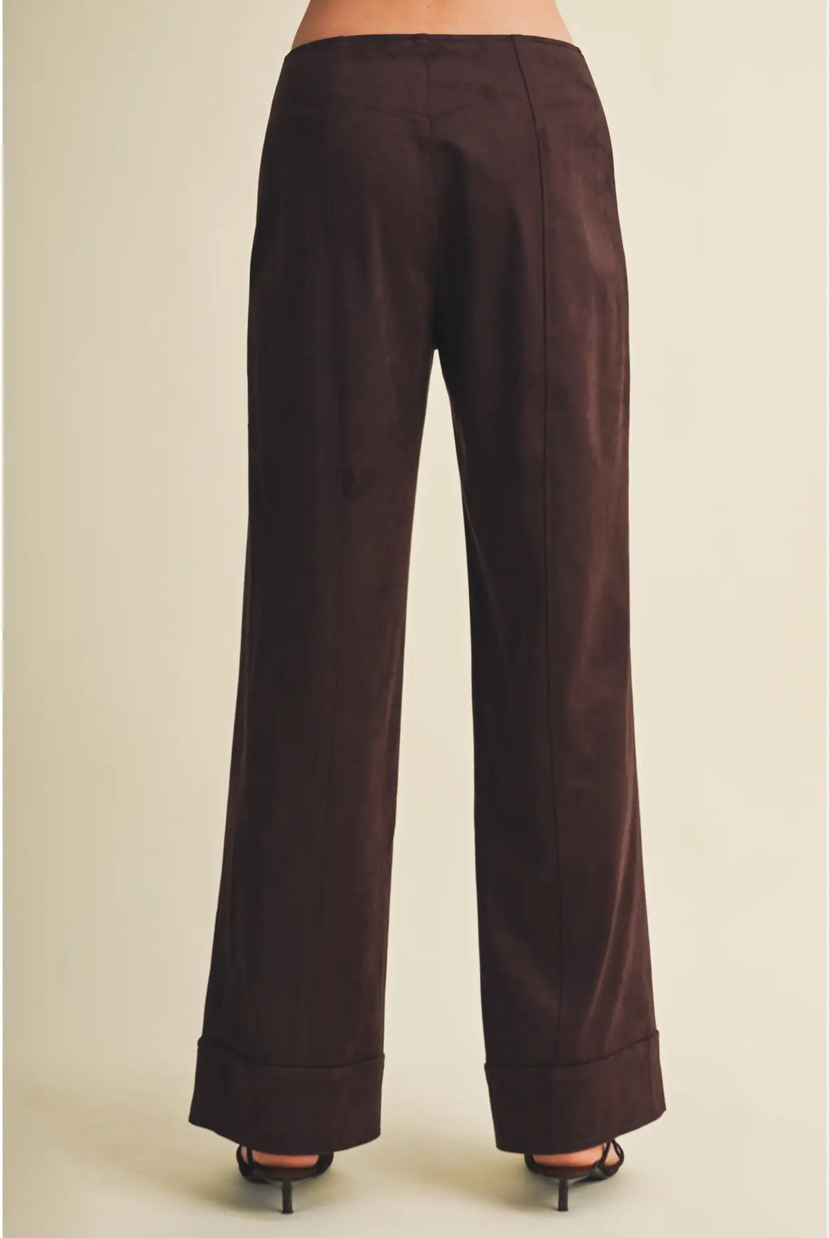 High-waisted faux suede pants with a slim wide-leg silhouette, pintuck detailing, full length, and wide cuffed hems. Model is 5'9" and wearing a size Small.