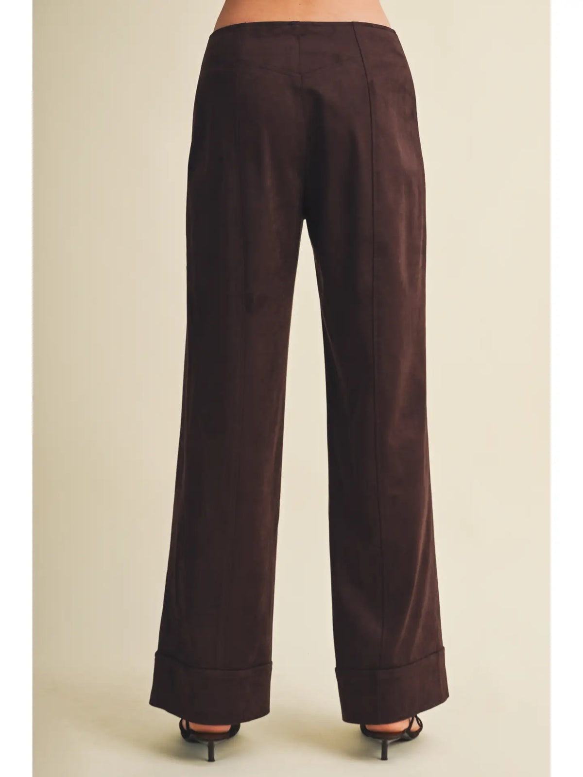 High-waisted faux suede pants with a slim wide-leg silhouette, pintuck detailing, full length, and wide cuffed hems. Model is 5'9" and wearing a size Small.