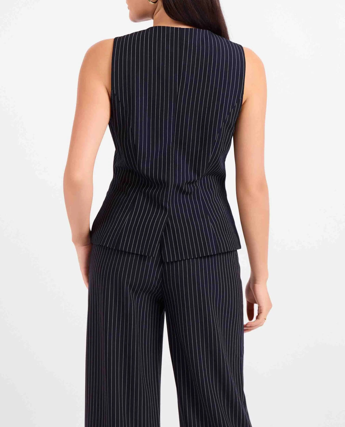 The Sadie & Sage East Gate Pinstripe Waistcoat brings a polished, modern feel to classic tailoring. Designed with a structured silhouette and timeless pinstripe pattern, this versatile vest is perfect for dressing up or styling more casually. Pair it with the matching East Gate Pinstripe Pants for a chic, coordinated set