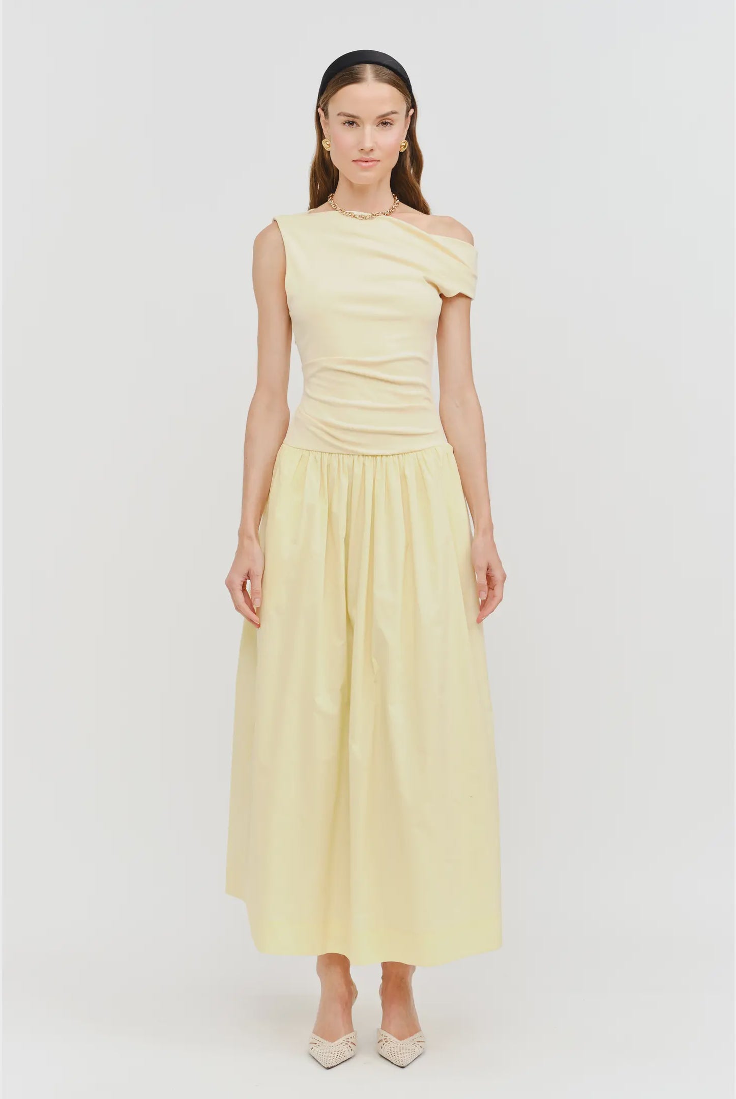 woman wearing sleeveless off the shoulder maxi butter yellow dress