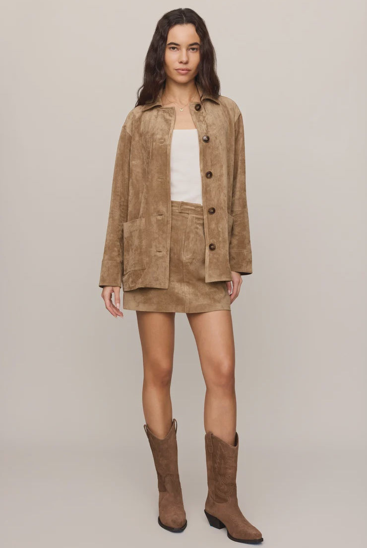 Faux suede statement coat with a relaxed silhouette, classic collar, long sleeves, button-front closure, and roomy patch pockets. Finished in a soft, midweight fabric for an elevated everyday layer.