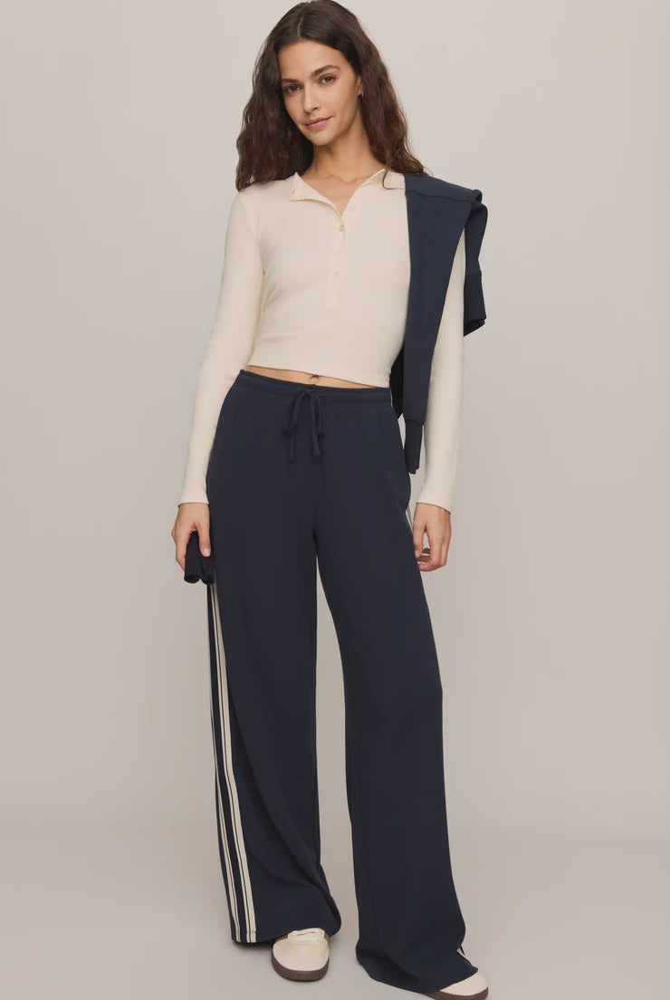 Fitted long-sleeve henley top in soft cotton modal rib fabric with a cropped silhouette, henley neckline, and functional button-front placket. The comfortable stretch fabric creates a flattering fit, making it ideal for casual wear, layering, or pairing with workout-inspired outfits.