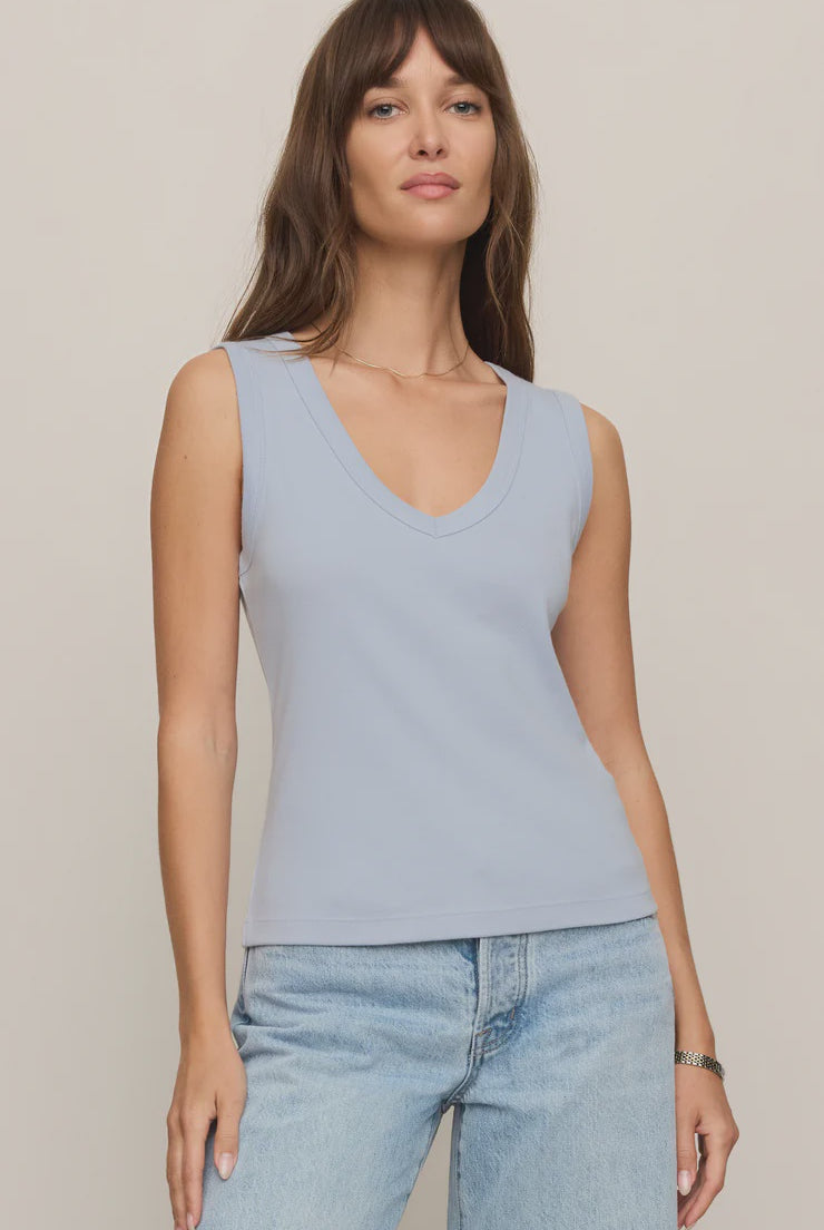 Model wearing the Z Supply Ellie V-Neck Tank, a sleeveless ribbed cotton tank featuring a flattering V-neckline, wide bra-friendly straps, and a fitted silhouette. The versatile essential is styled with casual bottoms for an effortless everyday look.