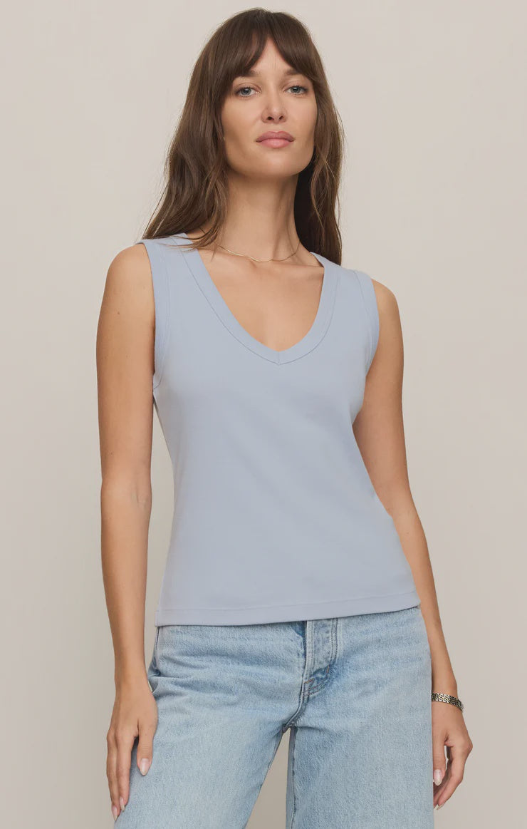 Model wearing the Z Supply Ellie V-Neck Tank, a sleeveless ribbed cotton tank featuring a flattering V-neckline, wide bra-friendly straps, and a fitted silhouette. The versatile essential is styled with casual bottoms for an effortless everyday look.