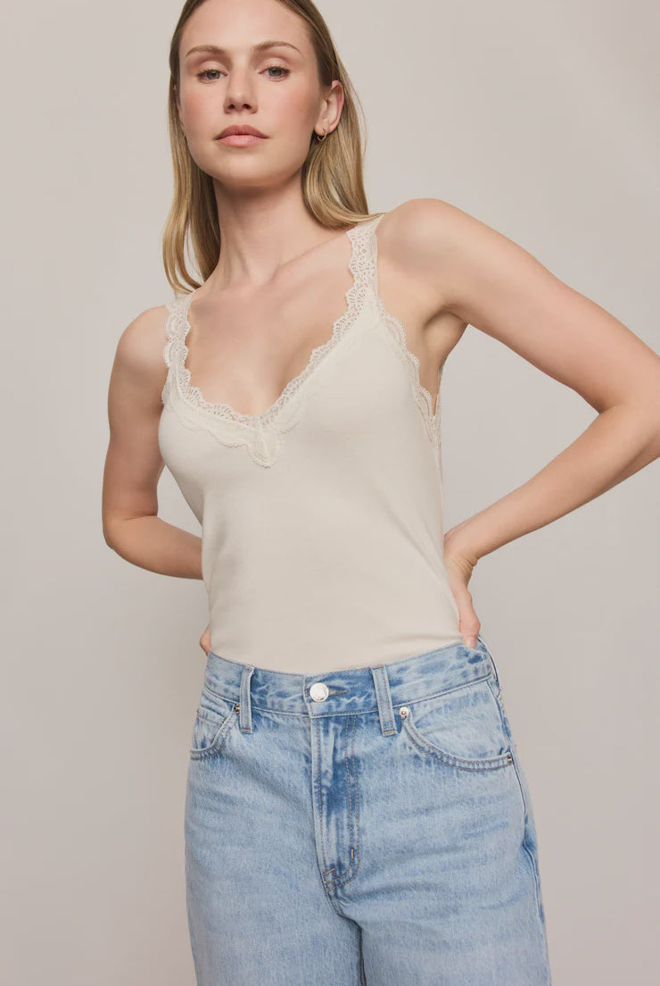 Fitted baby rib cotton tank with a lace-trimmed V-neckline and wide straps. A soft, feminine essential that's perfect for layering or wearing on its own.