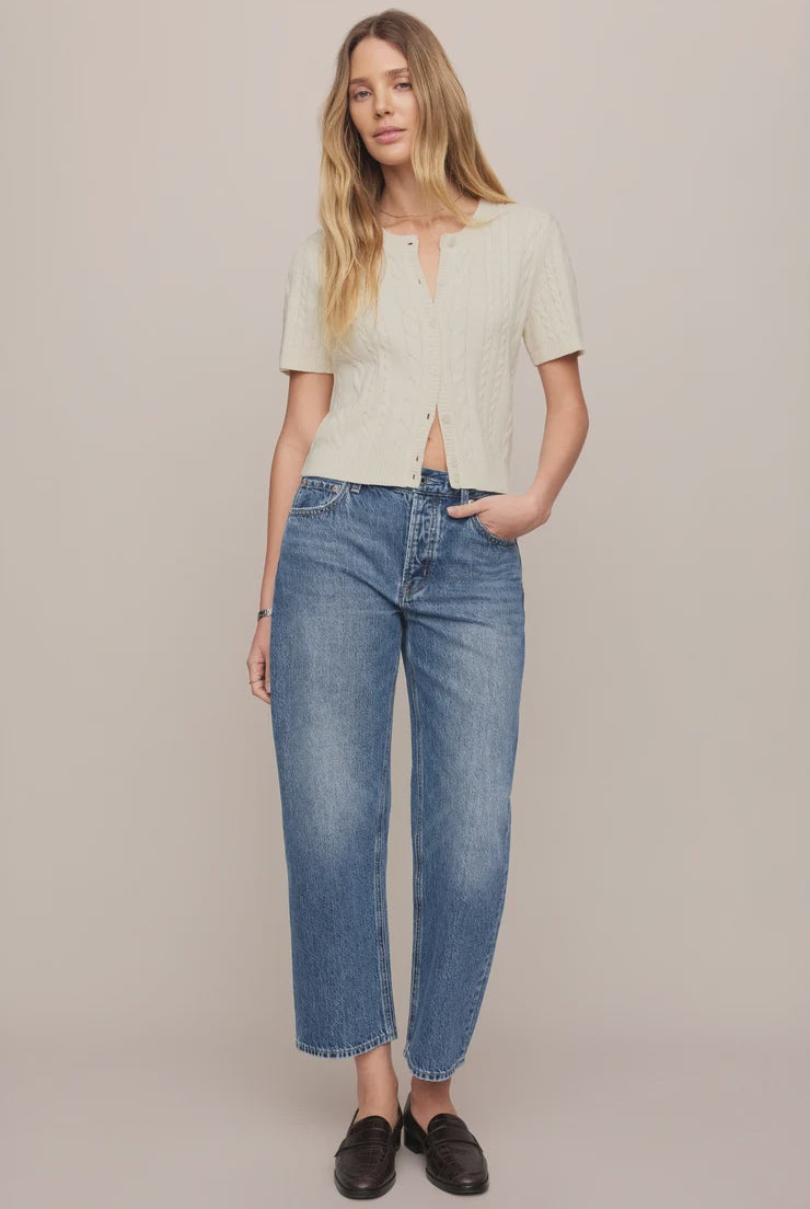 Vintage-wash blue mid-rise jeans featuring a relaxed bowed-leg silhouette, ankle-length hem, and classic five-pocket styling.