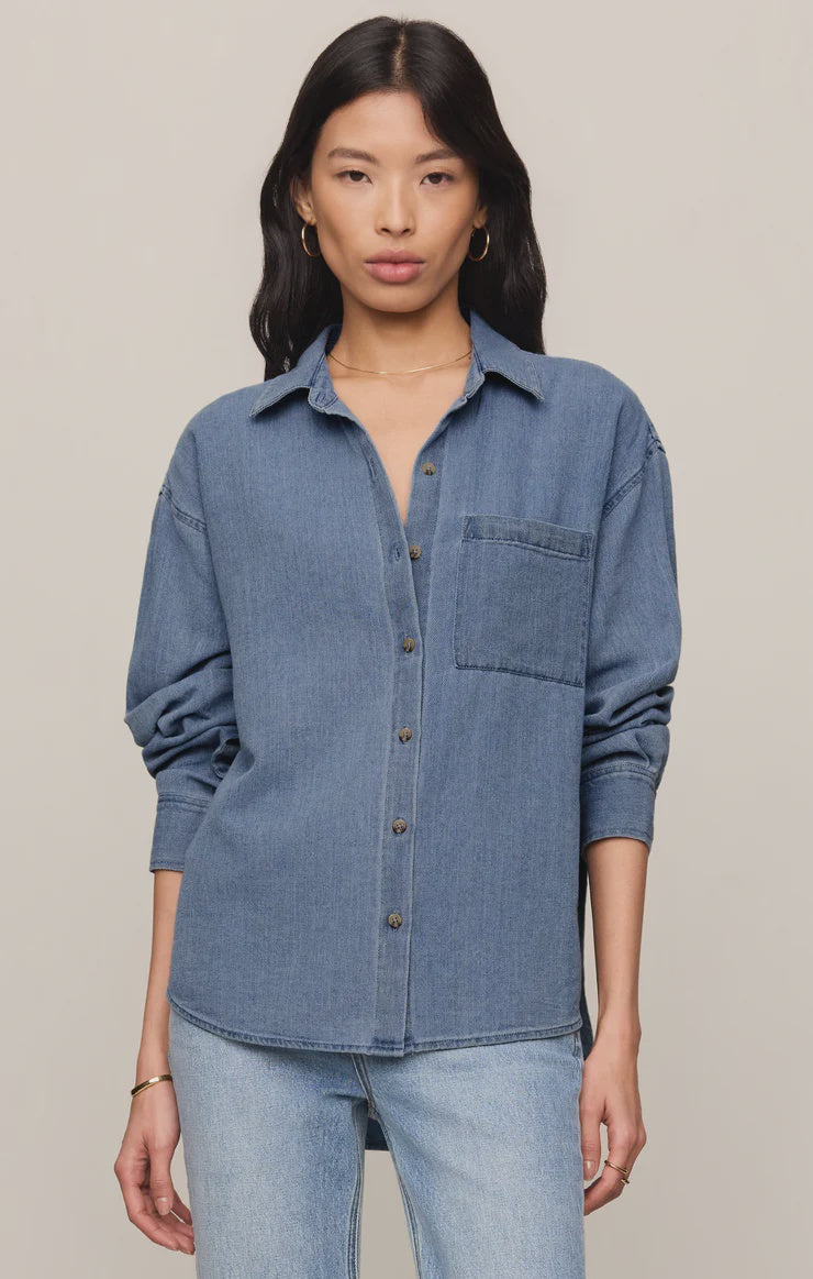 Relaxed-fit indigo cotton twill button-up shirt with a collared neckline, long sleeves, button-front closure, and a single chest pocket. Made from 100% cotton with a soft, drapey feel.