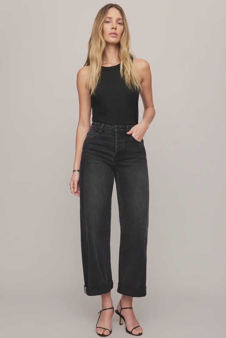 High-rise washed black jeans featuring a relaxed bowed-leg silhouette, full-length hem, and contrast whipstitch detailing inside the cuff.