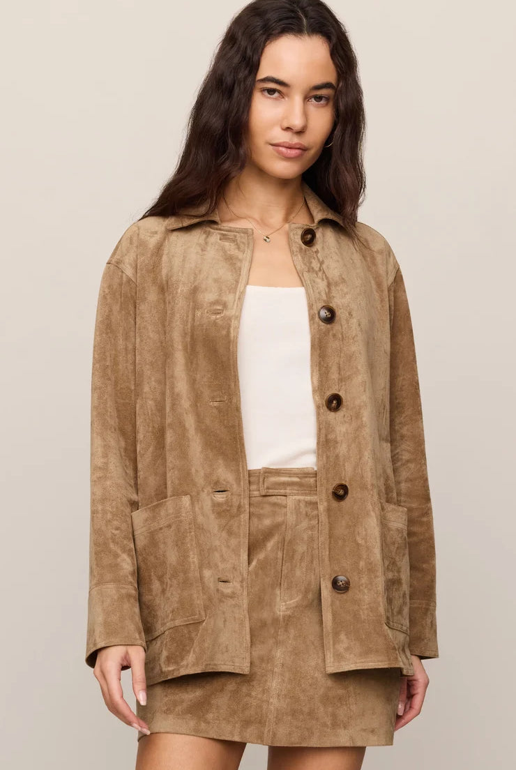 Faux suede statement coat with a relaxed silhouette, classic collar, long sleeves, button-front closure, and roomy patch pockets. Finished in a soft, midweight fabric for an elevated everyday layer.