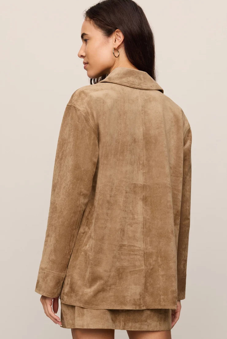 Faux suede statement coat with a relaxed silhouette, classic collar, long sleeves, button-front closure, and roomy patch pockets. Finished in a soft, midweight fabric for an elevated everyday layer.