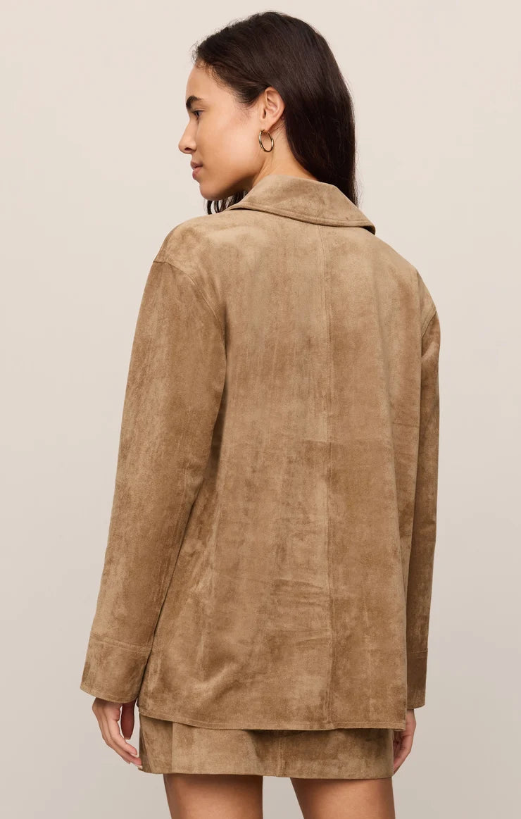 Faux suede statement coat with a relaxed silhouette, classic collar, long sleeves, button-front closure, and roomy patch pockets. Finished in a soft, midweight fabric for an elevated everyday layer.