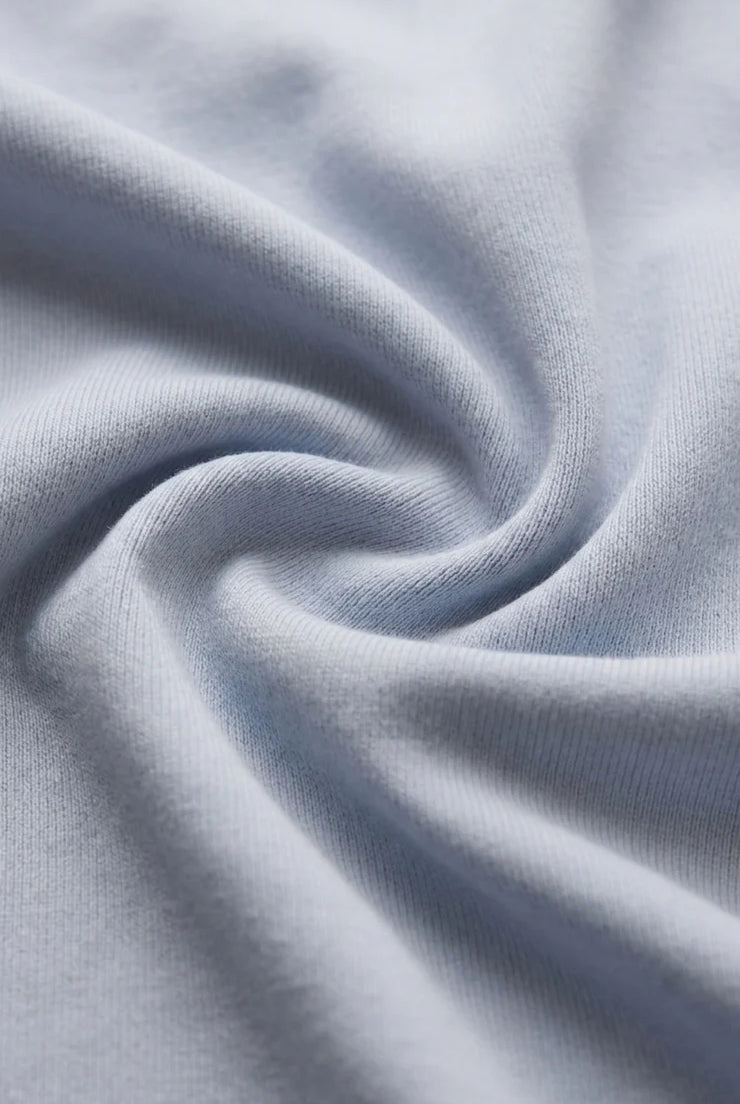 Close-up of the Z Supply Ellie V-Neck Tank's soft 100% cotton baby rib fabric, highlighting its fine ribbed texture, smooth finish, and comfortable stretch with a substantial yet breathable feel.